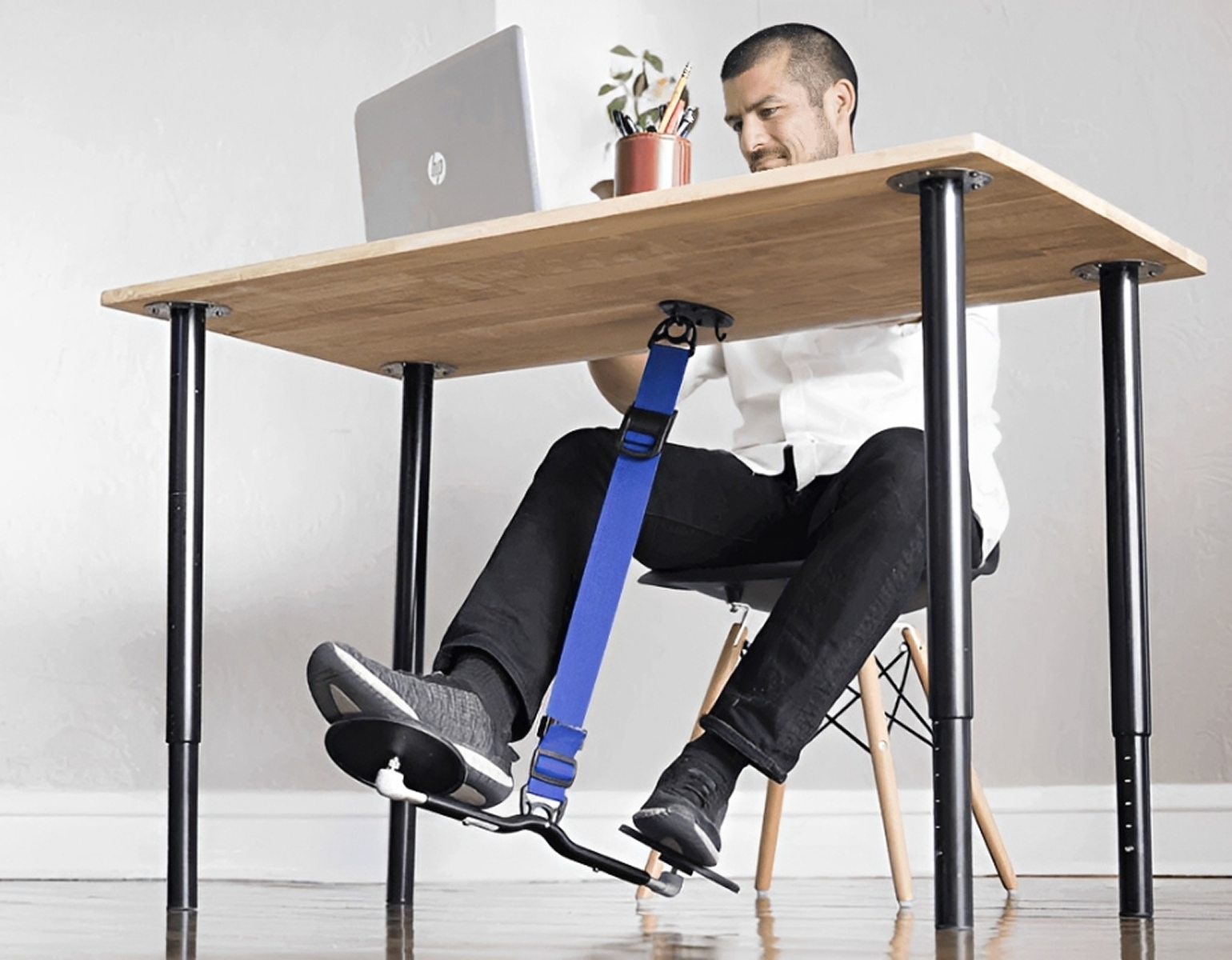 Individual seated with blue footrest accessory